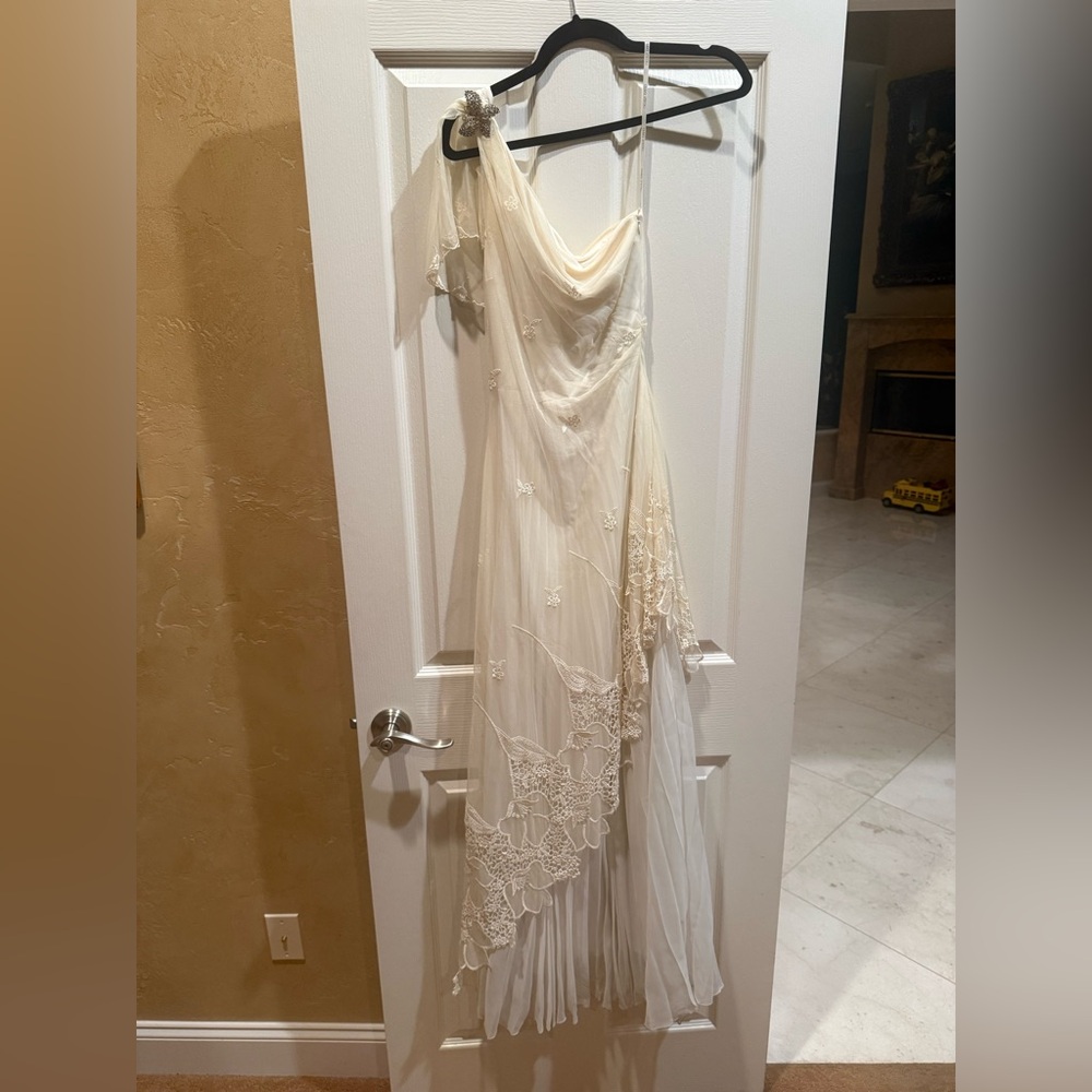 Nicole Bakti lace white gown with rhinestone butterfly detail on shoulder